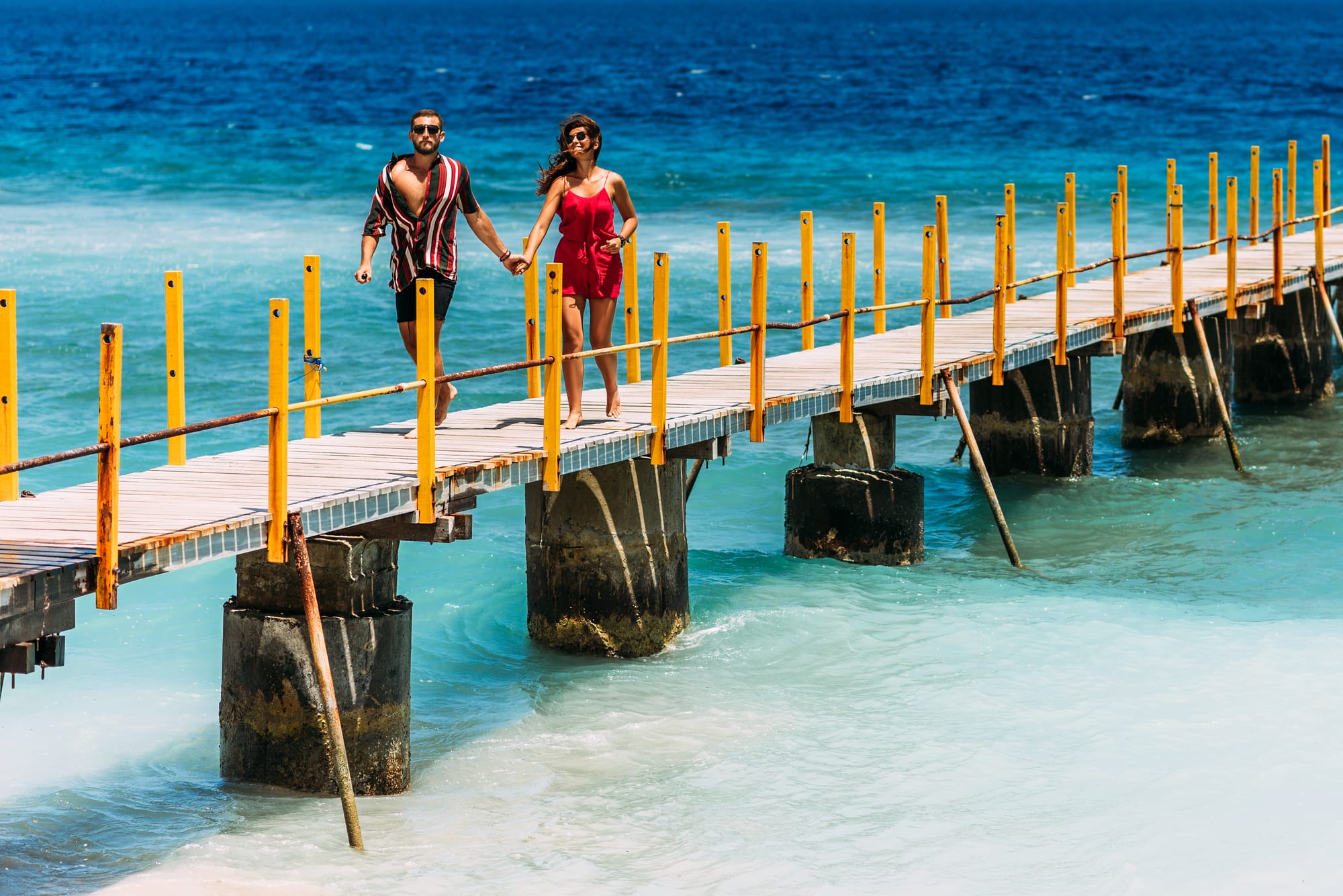 a-couple-in-love-holding-hands-runs-along-the-pier-2025-01-08-19-07-17-utc.jpg